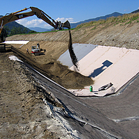 Covering of the water channel by installing concrete mats and subsequent sand filling with the help of an excavator