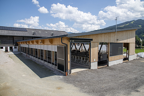 Exterior view of a dairy cow barn with a barn climate control system