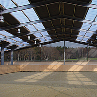 Interior view of an indoor riding arena with Lubratec wind protection system