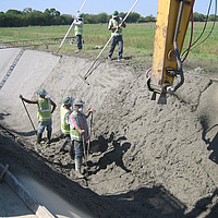 Workers installing Huesker Canal³ membrane