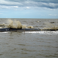 Groynes and breakwaters in the sea with waves for coastal protection