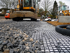 Installation of geosynthetics and fill stone revetment for base course reinforcement and soil stabilization of the road network.