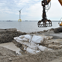 Installation of filled SoilTain Bags with an excavator