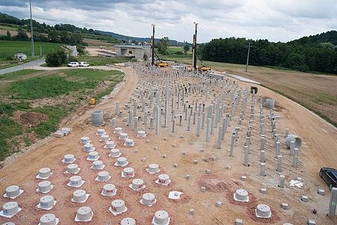 Foundation of the dams on precast concrete driven piles with a geogrid-reinforced foundation pad