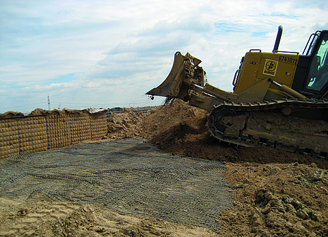 Bulldozer moves earth for the noise barrier