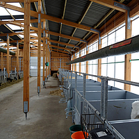 Lubratec Tube Cool suspended from the ceiling above empty stalls