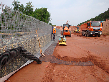 The supporting structure is erected by staff and various machines.