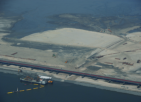 Aerial view of a large construction site for a dam lining