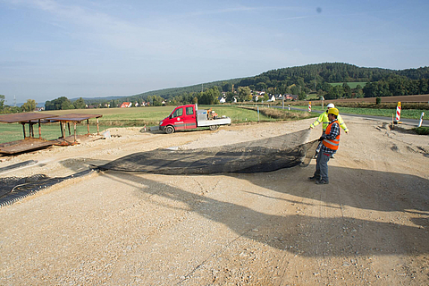 Workers are laying Fortrac on a building site