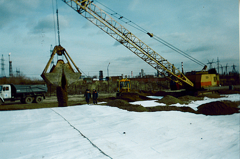 An excavator is spreading earth on Stabilenka