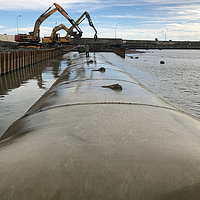 SoilTain hoses fully installed in the harbor as coastal and bank protection