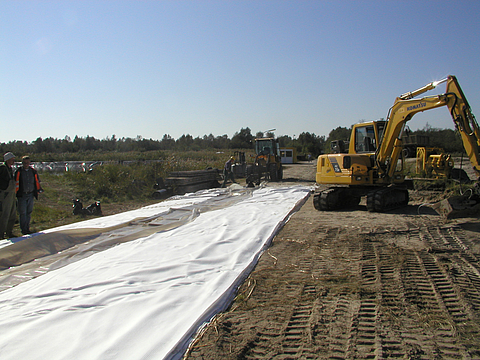 A building site with various pieces of construction machinery and workers