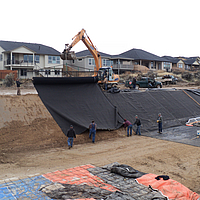Installing Ultimat nonwoven geotextile on canal slope