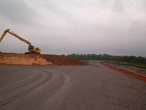 Earth embankment at the landfill site, constructed using an excavator