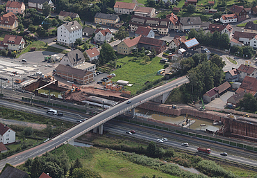 Aerial view of the large construction site next to a motorway