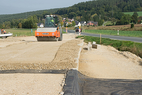 Rollers work the ballast over the Fortrac