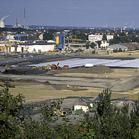 Brownfield site showing visible signs of industrial contamination before remediation