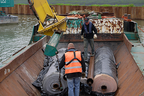 Loading from a boat using an excavator