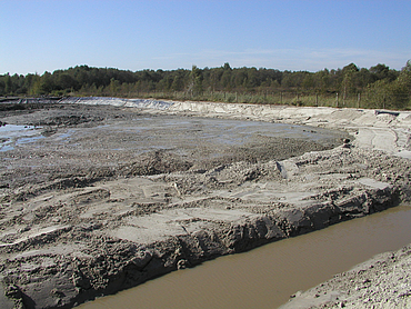 A muddy area with waterholes in the countryside