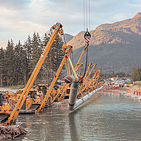 Cranes lift a pipeline