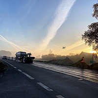 Application of Hatelit asphalt reinforcement on a road